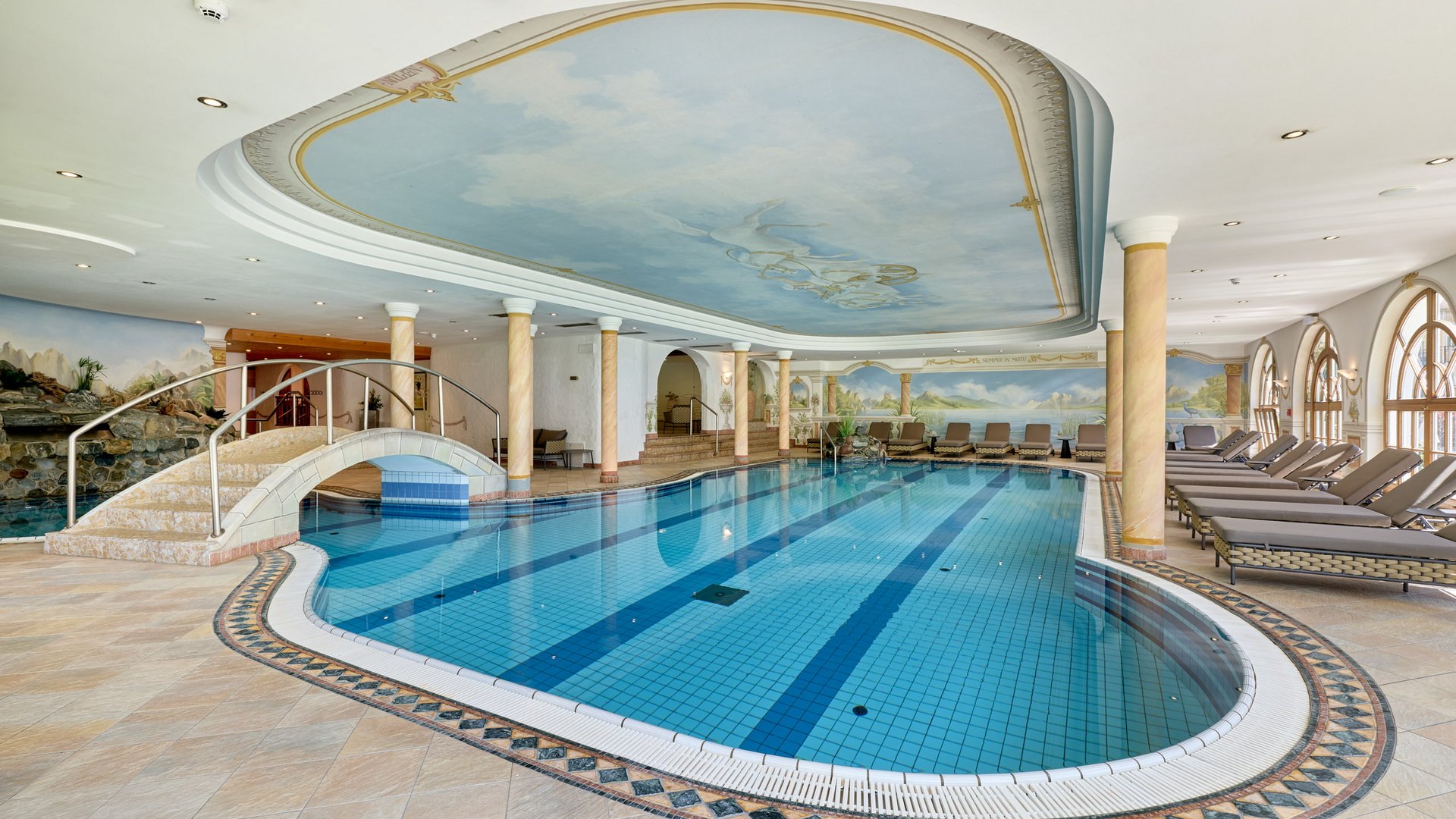 Stubaital: das Hotel mit Pool Luxuriöses Hallenbad mit dekorativer Decke und Liegestühlen